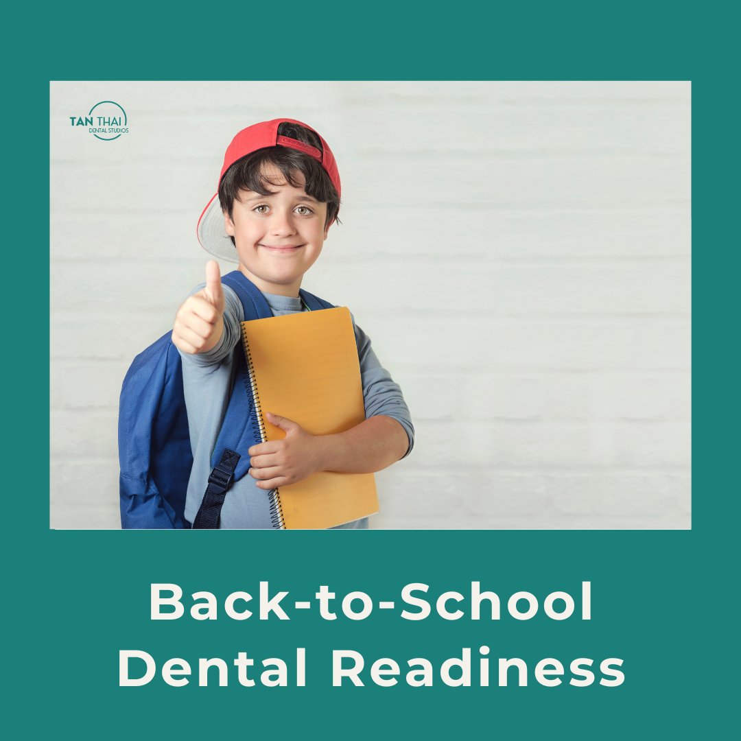A smiling young boy sitting in a dental chair during a back-to-school checkup